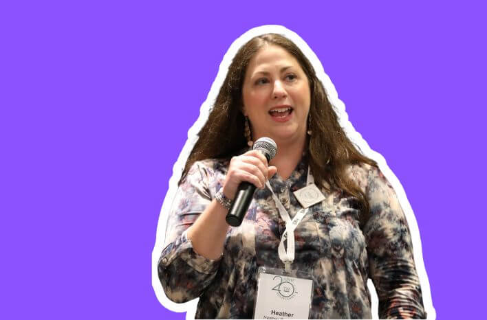 Heather Burchfield holding a microphone and wearing an AISAP Annual Conference badge. Heather serves as the Director of Partner Success at Truth Tree specializing in helping schools get discovered by right-fit families.
