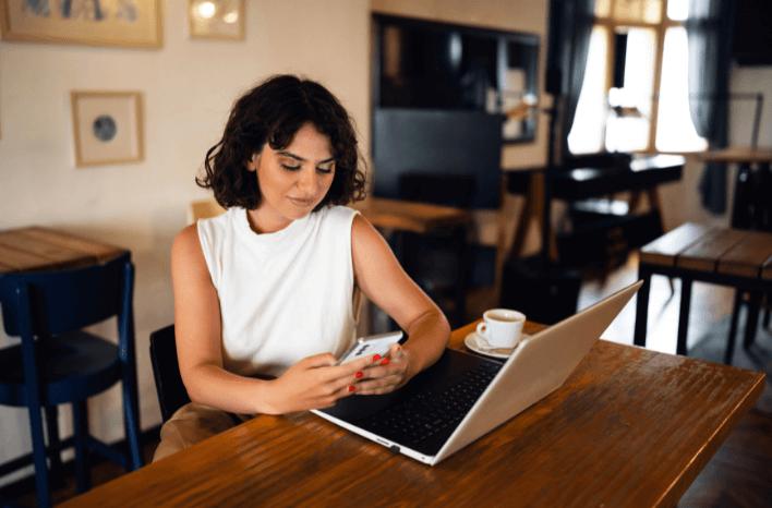 Parent researching school options at café.